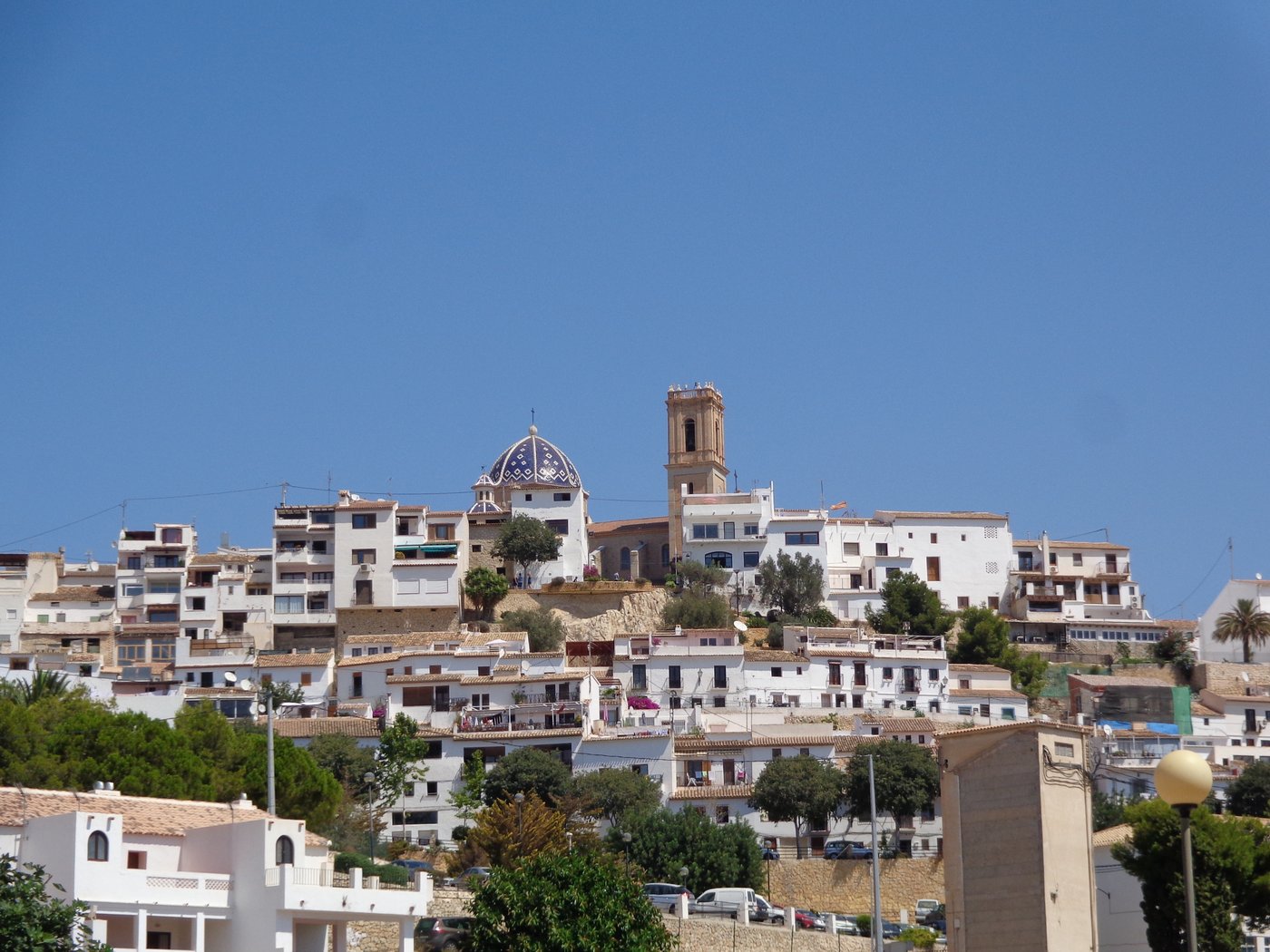 Altea's old town stacked up the hillside with the blue-tiled dome and bell tower at the top